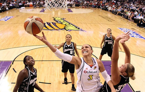 women basketball player lays up a basketball just under the hoop, arizona mercury players
