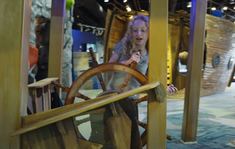 Girl pretending to drive a ship